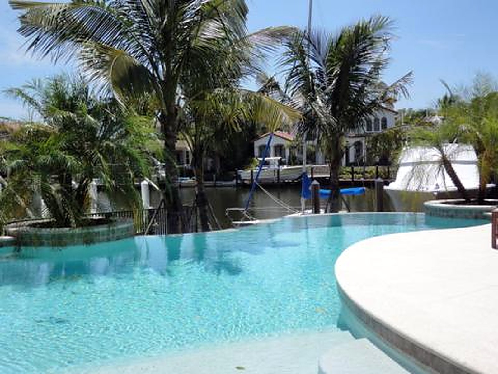 A finished Custom Pools of Naples build — a custom inground pool and outdoor living space in Southwest Florida.